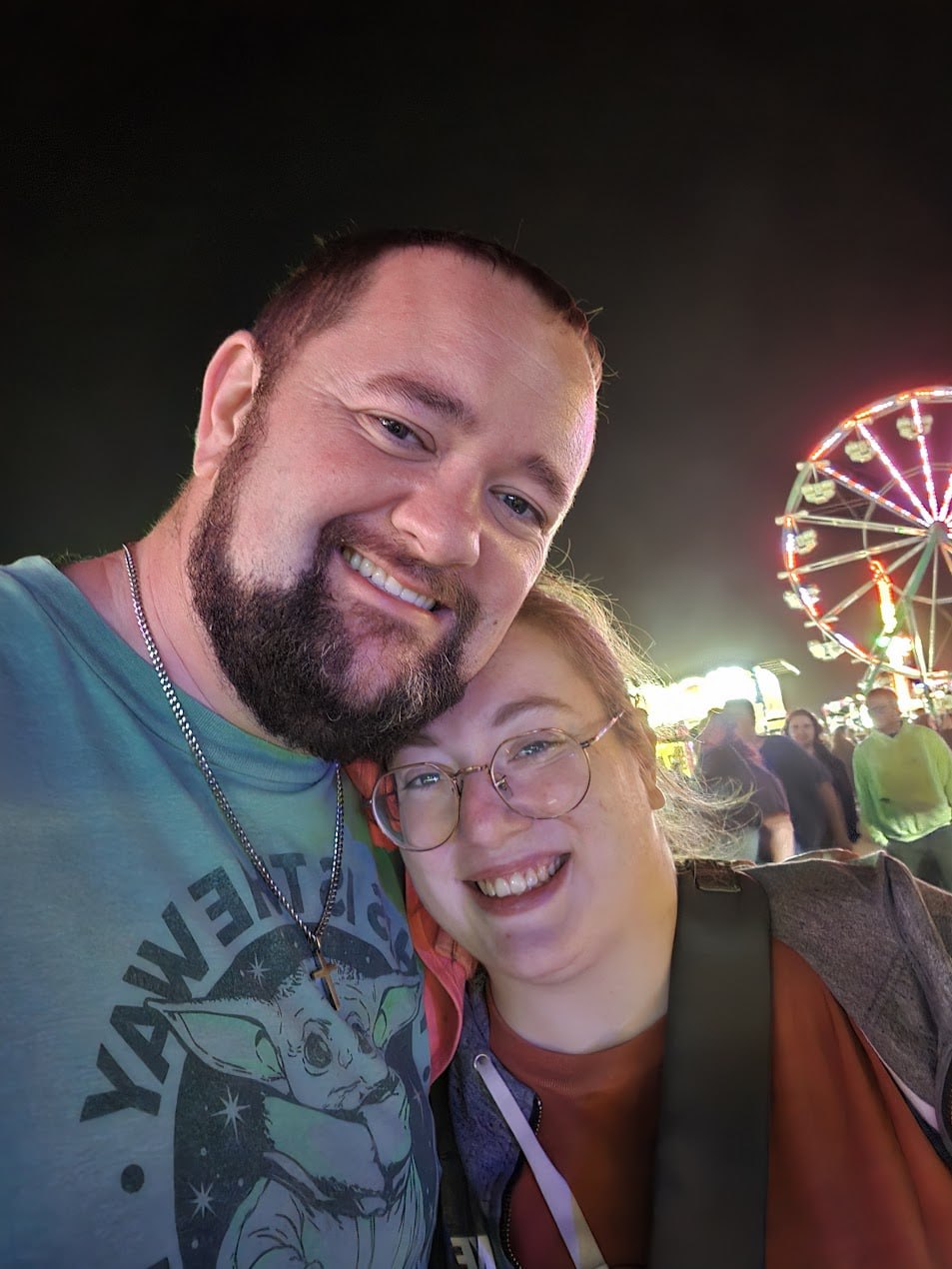 Matthew and Kellie smiling together at a fair